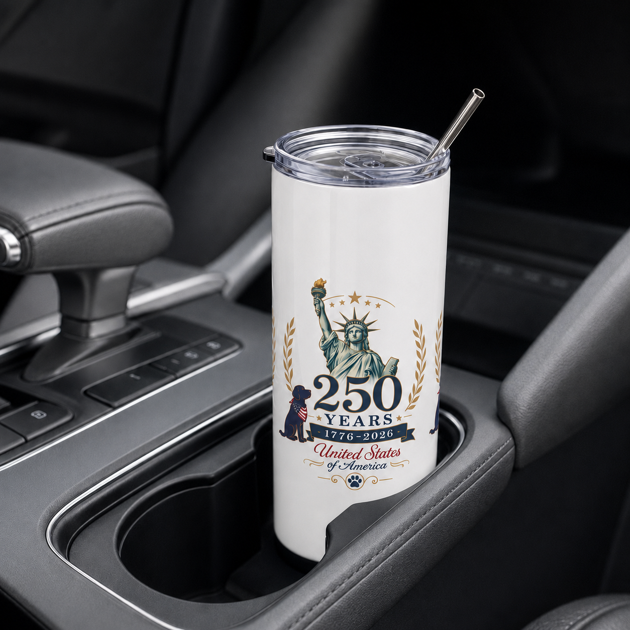     White 250 Years USA stainless steel tumbler in a vehicle cup holder with patriotic Statue of Liberty design.