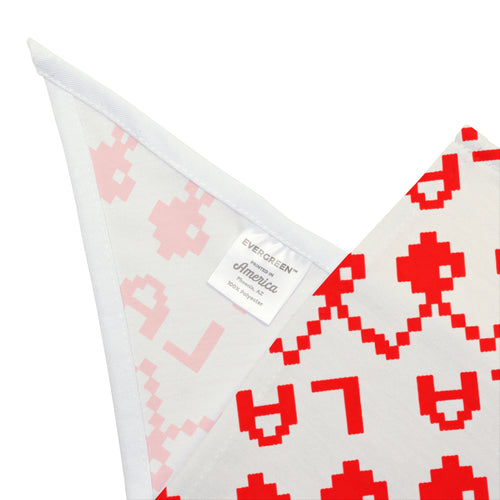A folded white fabric item, likely a blanket or throw, featuring a pixelated pattern in red and light pink. A white sewn-in label reads 'EVERFOREVER America Made in Austin, TX'.