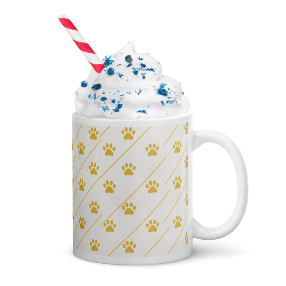Ivory Whisper mug with gold  paw print pattern, filled with a dessert, on a white background