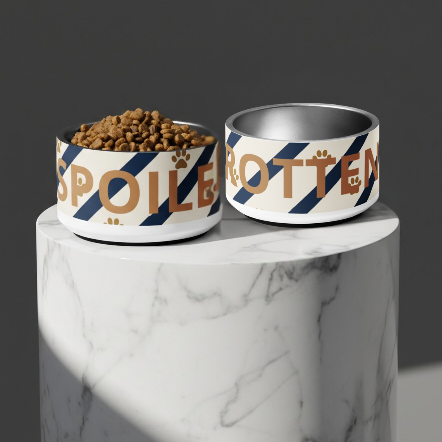 Two pet bowls with 'Spoiled Rotten' text on a marble surface.