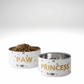 Two stylish stainless steel dog bowls with PAW PRINCESS lettering and modern patterns on a white background