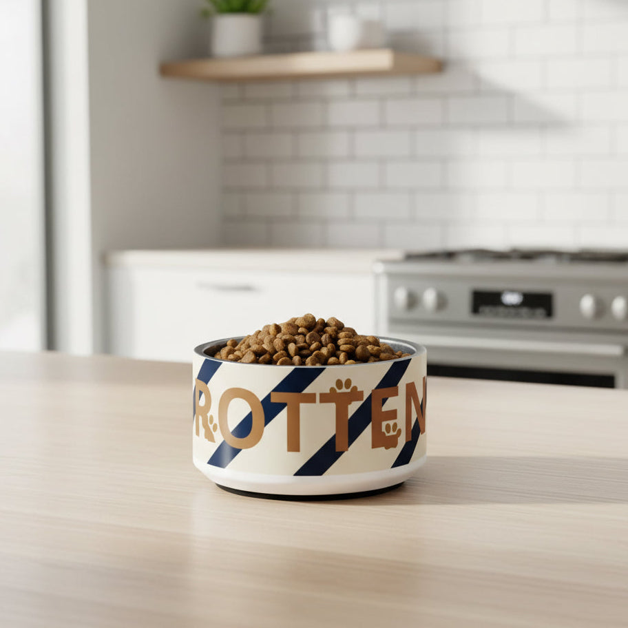 A navy blue stainless steel dog bowl diagonal stripes  rotten text sitting on a light wood counter