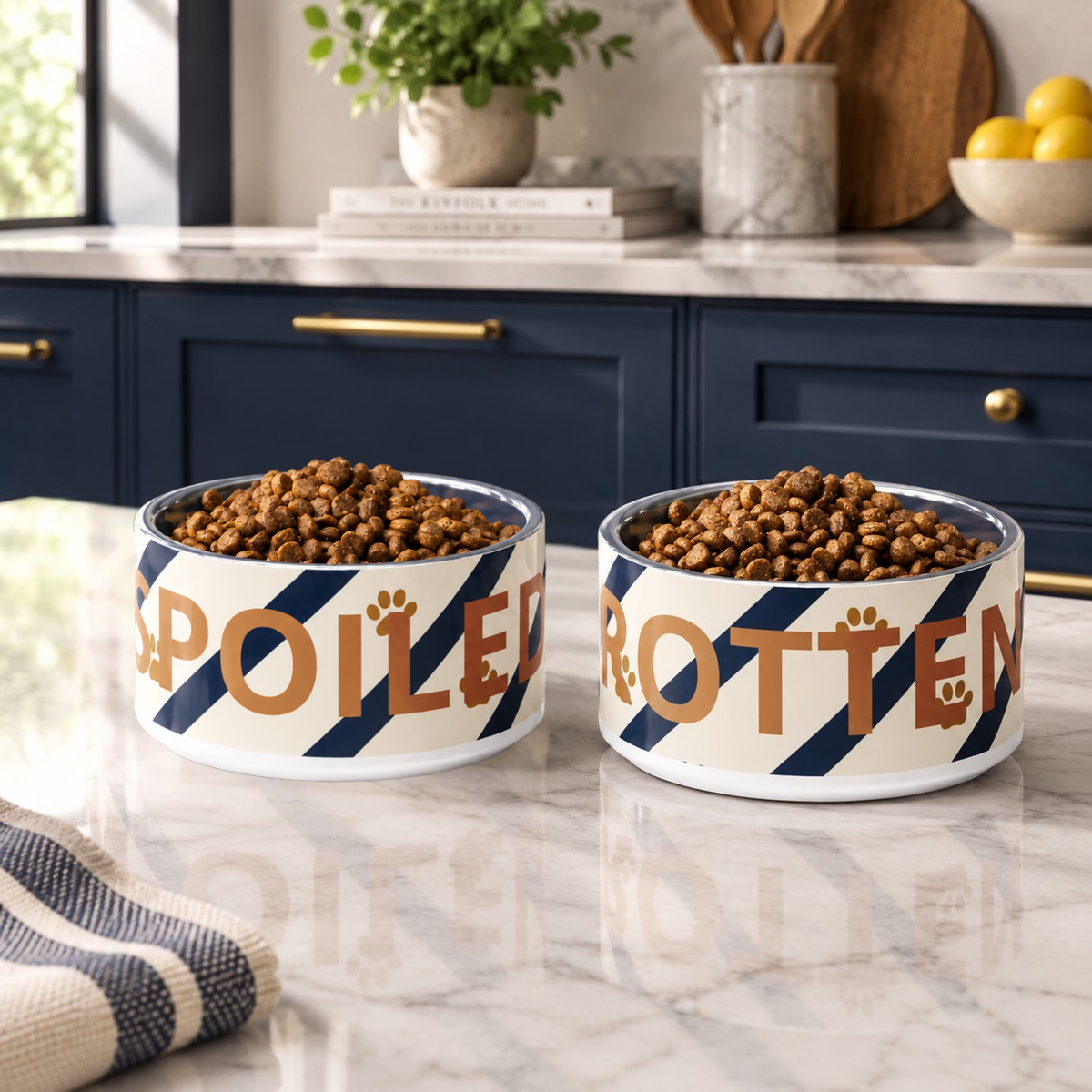 Two stainless steel dog bowls, 18 oz set with text one bowl 'Spoiled ' the other 'Rotten' with ivory, & blue strips, & paw print pattern. 