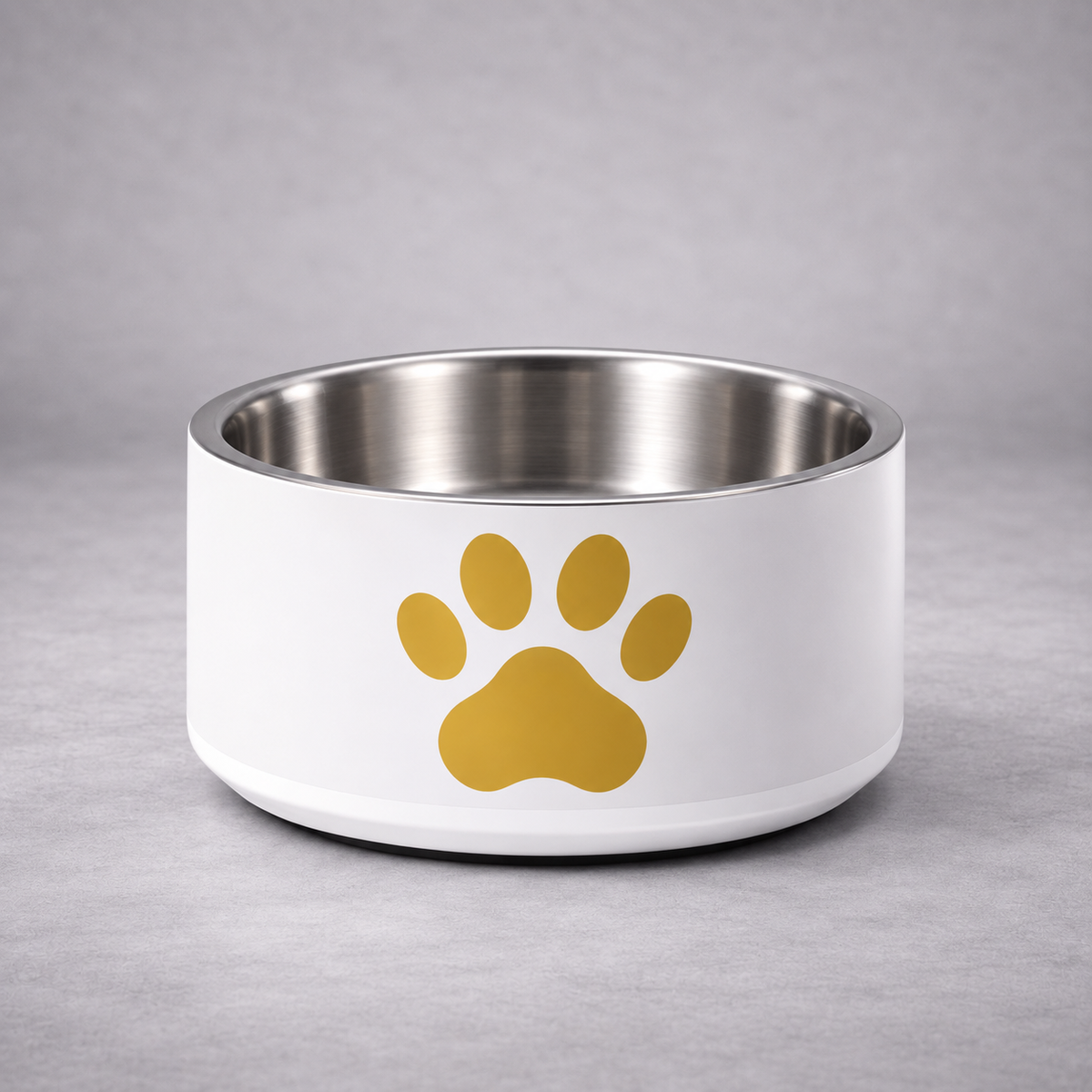 A ivory pet bowl with a stainless steel interior and a gold paw print graphic on the front, set against a neutral gray background.