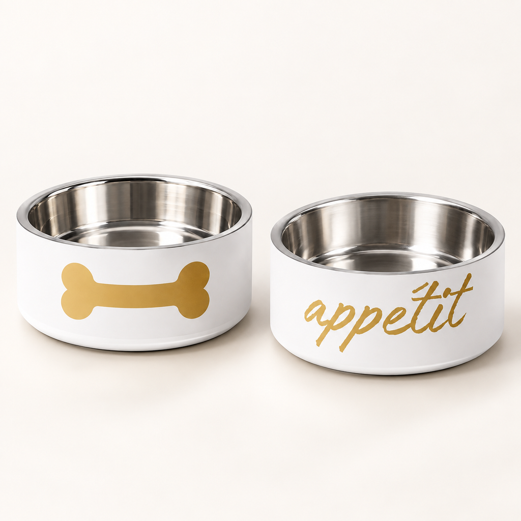 Two designer dog bowls, one with a bone design, the other with text that says 'appétit', on a white background.