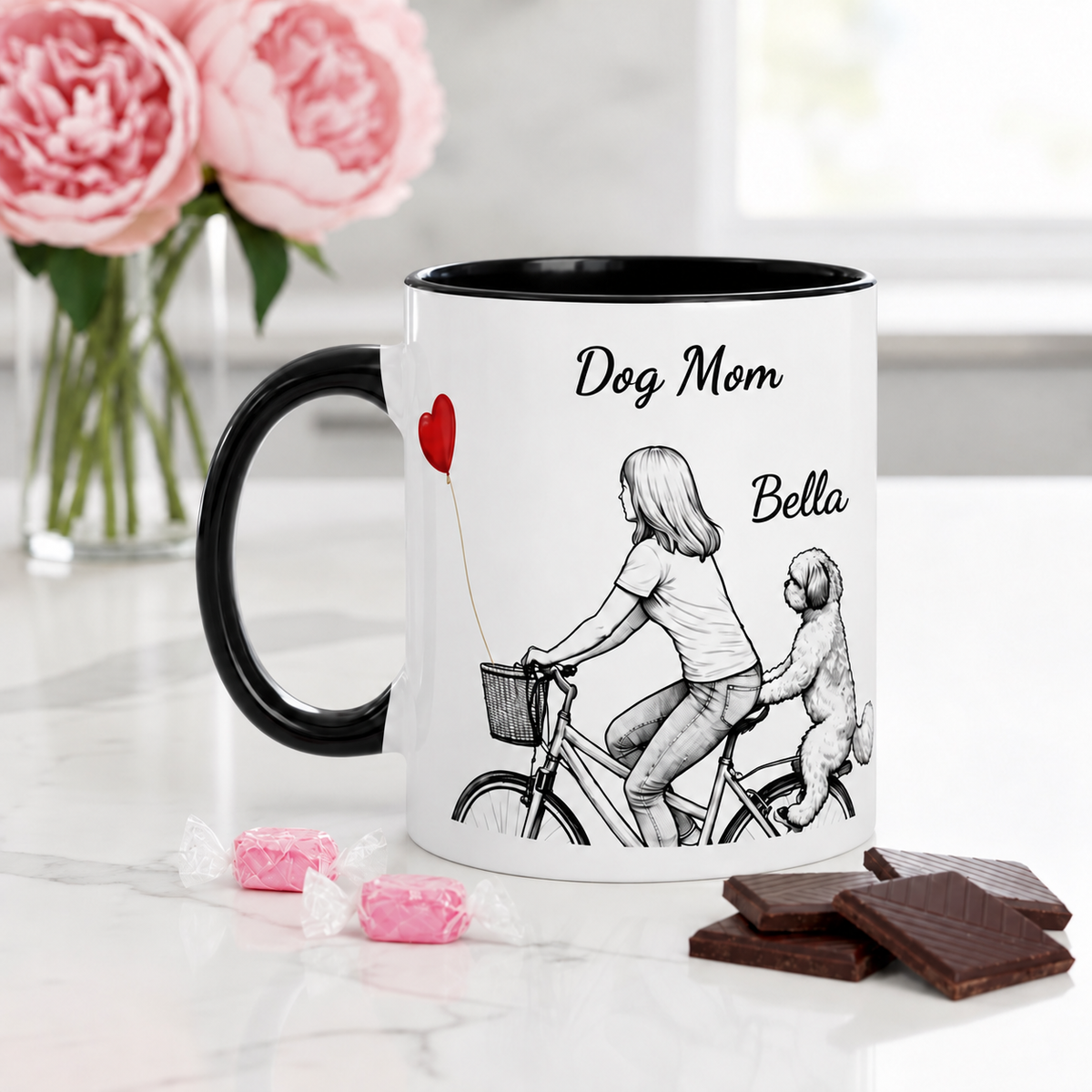 Mug with 'Dog Mom' text and illustration of a woman and dog on a bike, surrounded by flowers and chocolates.