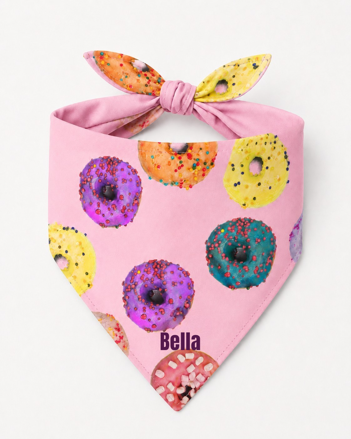 Pink dog bandana with colorful donut pattern and “pets” name branding on a white background