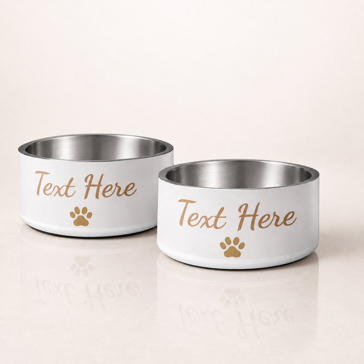 Two customizable ivory stylish dog bowls with stainless steel interiors, with the text 'Text Here' and a small gold paw print, on a light ivory background.