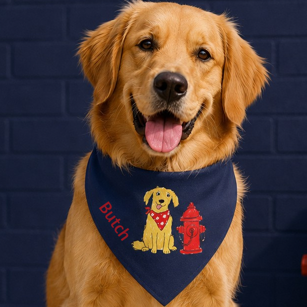 Dog wearing a navy blue bandana with a graphic and text, against a dark blue brick wall.