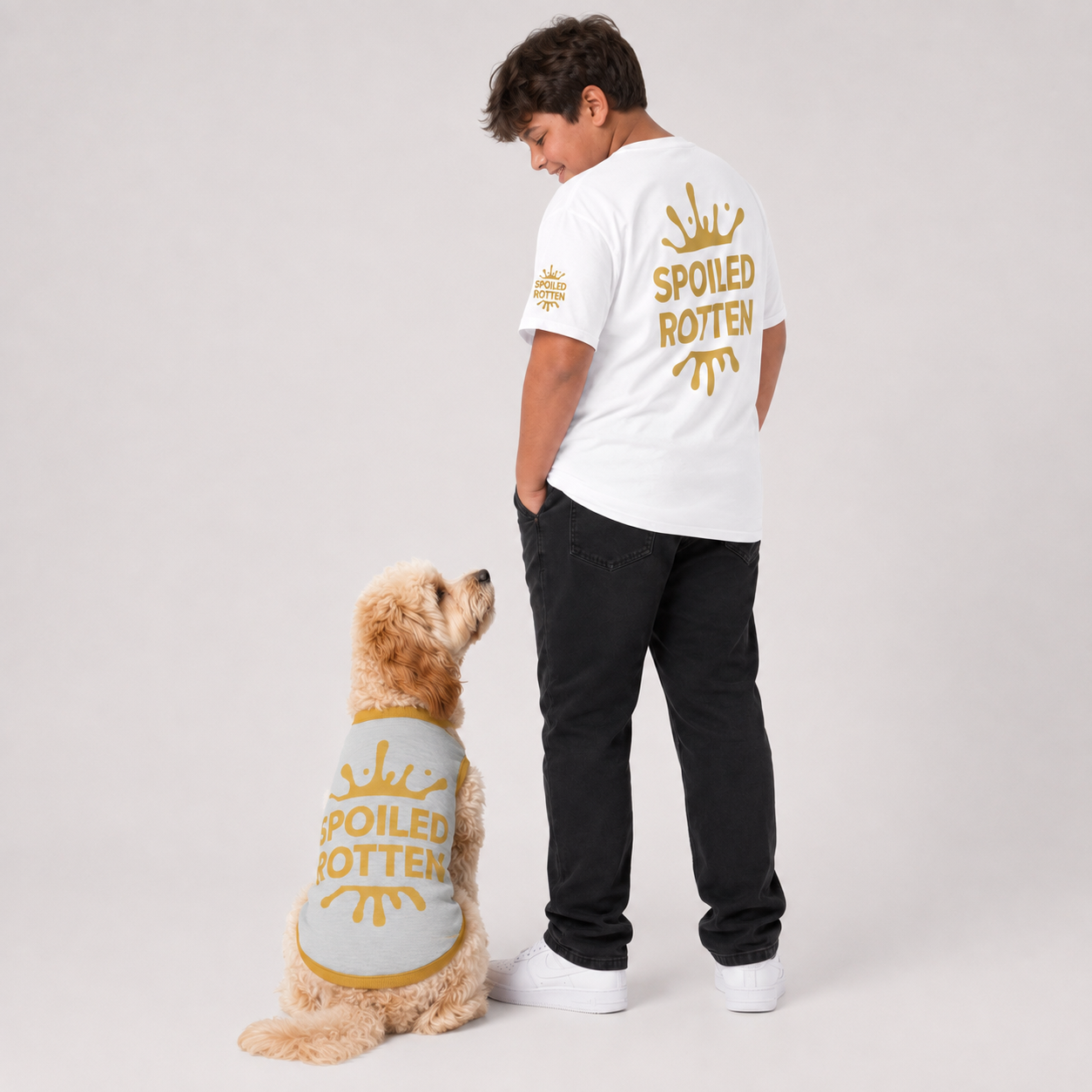 A man and a dog are shown from behind wearing matching T-shirts  and dog sweater text reading 'SPOILED ROTTEN' and a gold splash. 