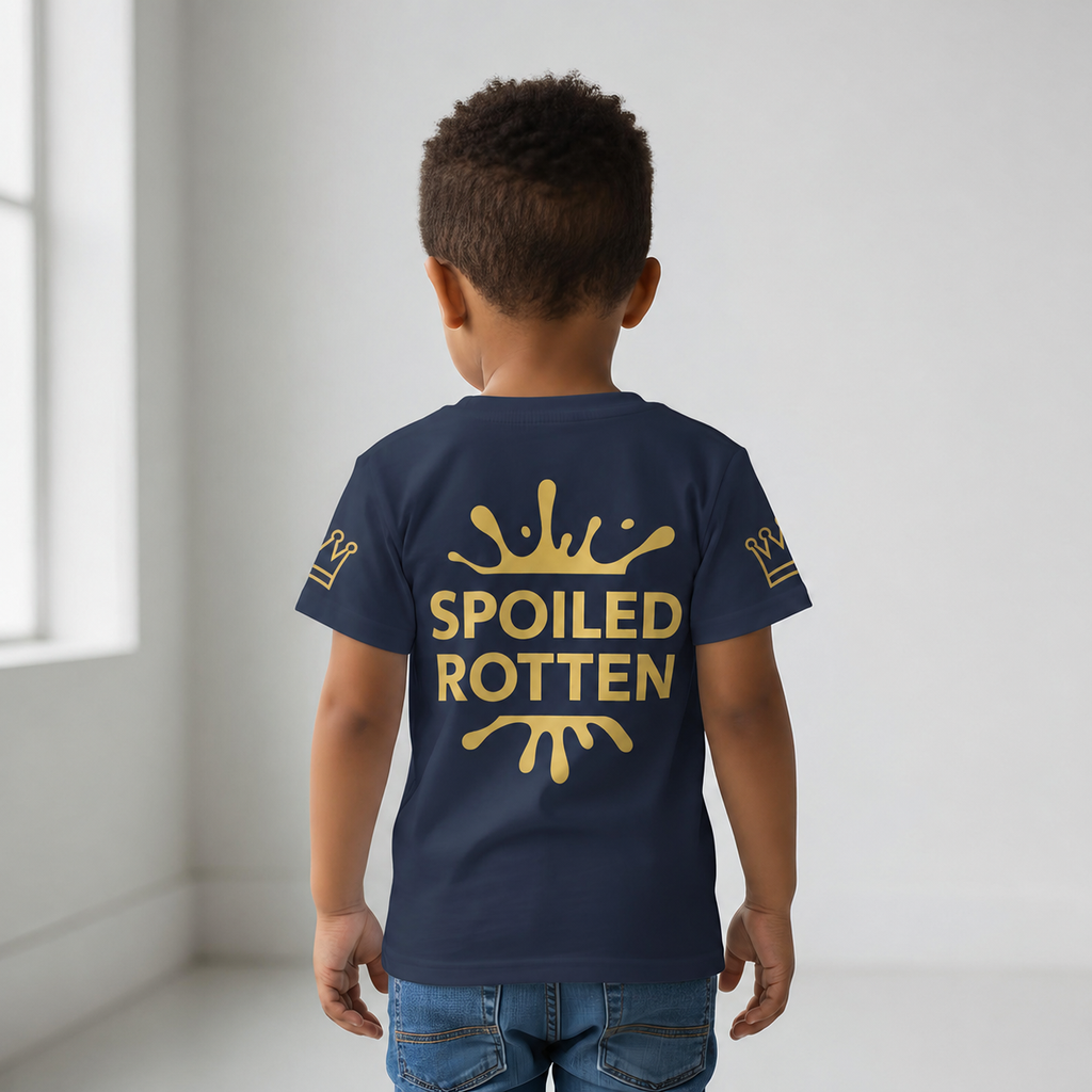 Back view of child wearing navy Spoiled Rotten T-shirt with a graphic gold splash design and gold crowns on sleeve