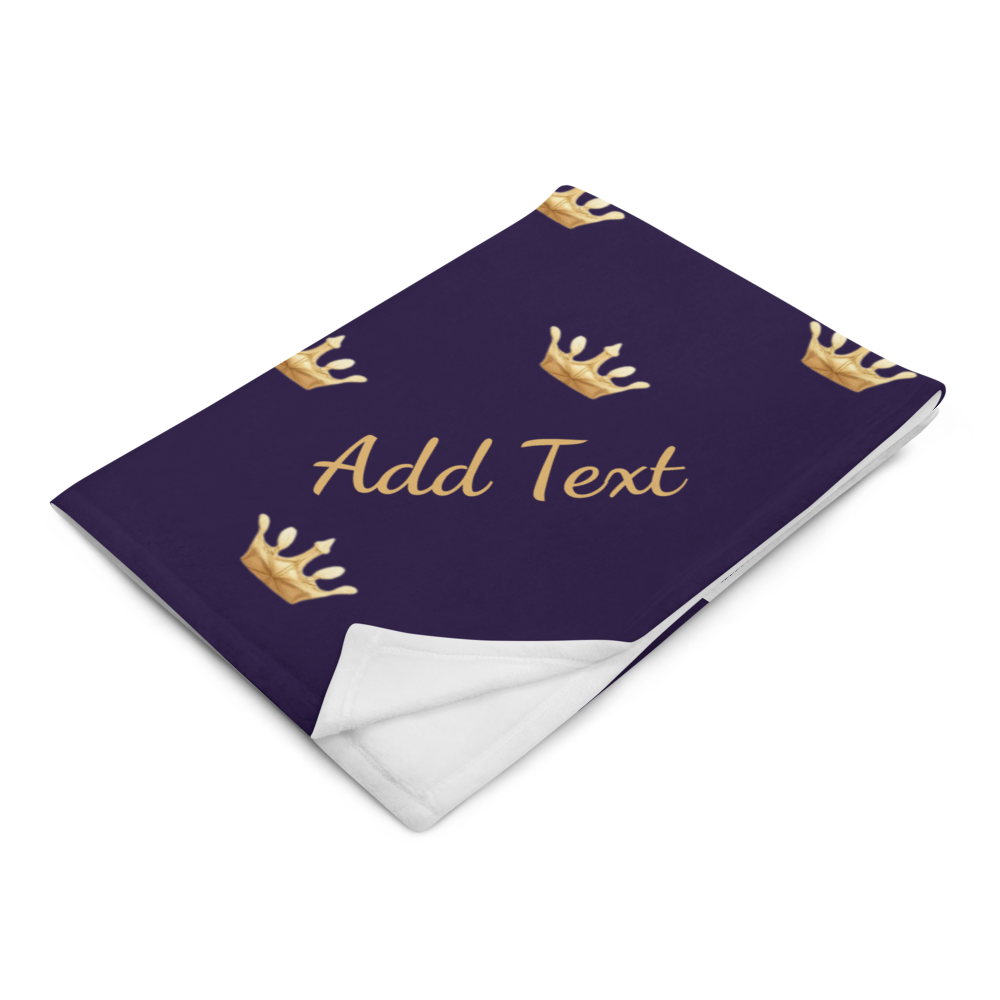 Folded blanket with gold crowns and 'Add Text' on a deep navy background