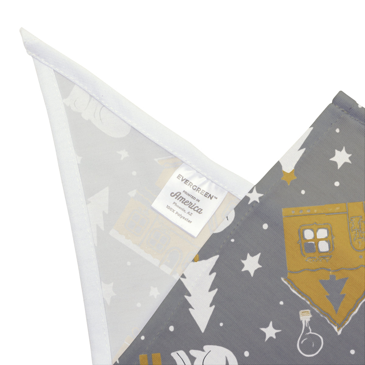 A folded dog bandana featuring a winter theme in a silver and gold winter pattern.