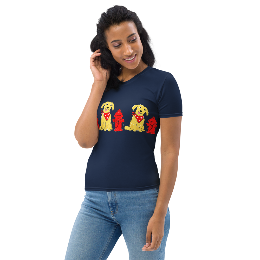 woman wearing a navy t-shirt with a  print of dogs wearing red bandanas next to red fire hydrants white background