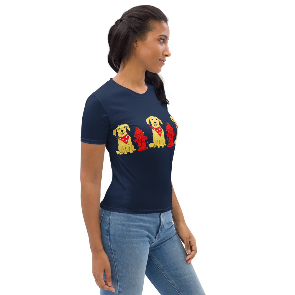 woman wearing a navy t-shirt with a  print of dogs wearing red bandanas next to red fire hydrants side view.