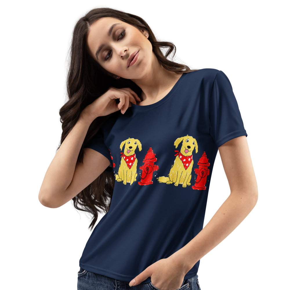A woman wearing a navy blue t-shirt with a graphic print of dogs wearing red bandanas next to red fire hydrants.