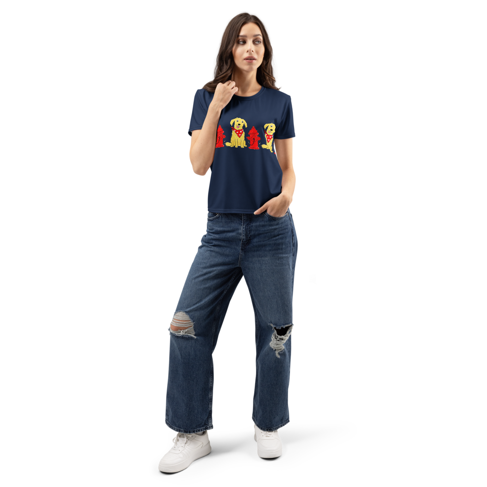 woman wearing a navy t-shirt with a  print of dogs wearing red bandanas next to red fire hydrants.